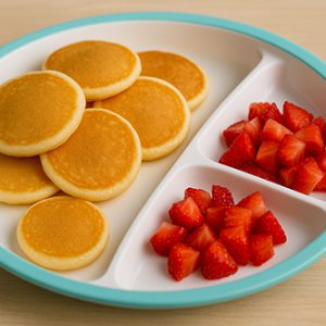 mini-pancakes with strawberries on the side